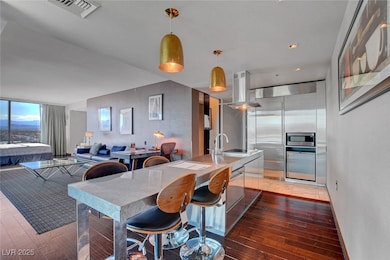 Kitchen with a sink, island exhaust hood, light wo