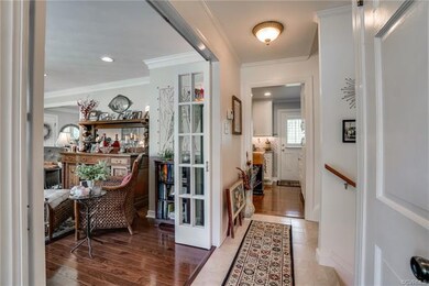 Entrance way with porcelain tile and hardwood floo