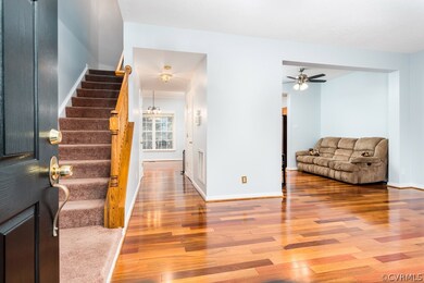 Enter and find open concept living room with hardw