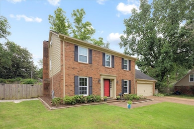 Colonial inspired home with a garage and a front l