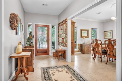 Welcoming entryway with tile flooring opens to a spacious dining room, creating an elegant first impression.