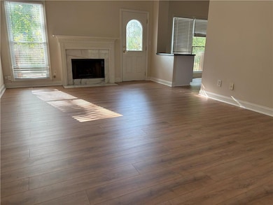 Unfurnished living room with a high end fireplace and wood finished floors
