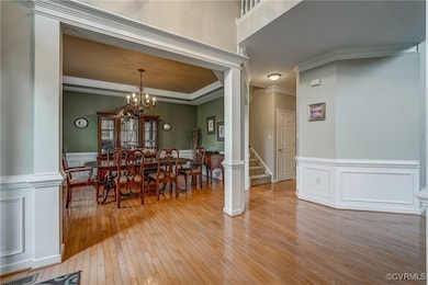 Dining space with light wood-style floors, stairs,