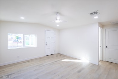 Empty room with light wood-style floors, a ceiling