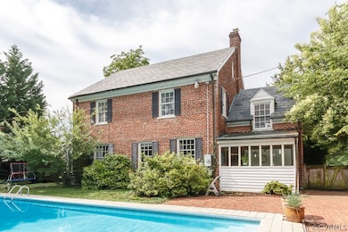 The back of this all brick colonial has mudroom off the side and access to a full bath and dressing area.