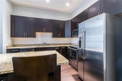 Kitchen featuring decorative backsplash, sink, sta
