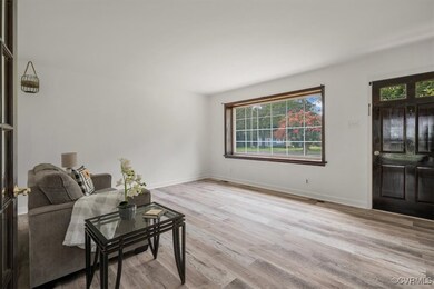 Living room with light hardwood / wood-style floor