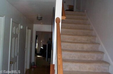Entry. Entry hall into living room with stairs to two upstairs bedrooms.