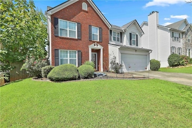 View of front of home with a garage and a front la