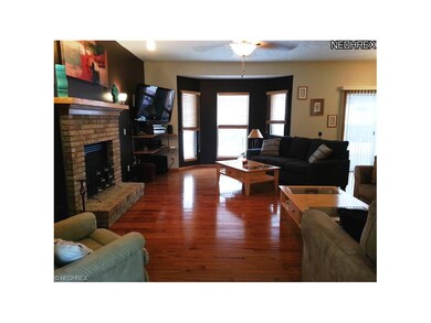 Family Room With Gleaming Hard Wood Floors And Bay