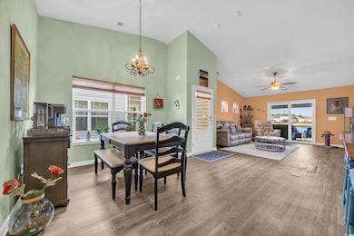 Dining room with ceiling fan with notable chandeli