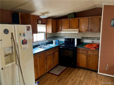 Kitchen with black range with electric stovetop, l