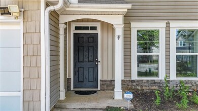 Property entrance featuring stone siding