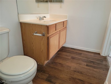 Bathroom with hardwood / wood-style floors, vanity