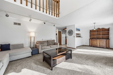 Living room with view of dining room and kitchen