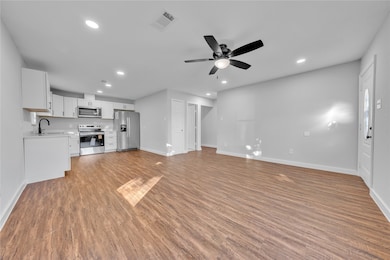 Unfurnished living room featuring light wood finished floors, recessed lighting, and a ceiling fan