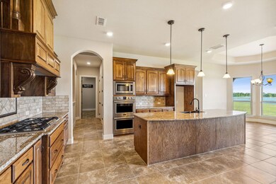 Kitchen features granite countertops, double oven,