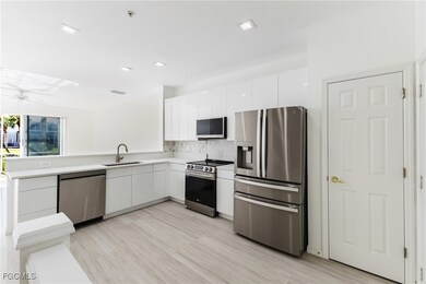 Kitchen featuring appliances with stainless steel finishes, white cabinets, modern cabinets, and quartz countertops