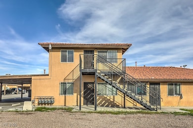 Rear view of house with stairway, stucco siding, a