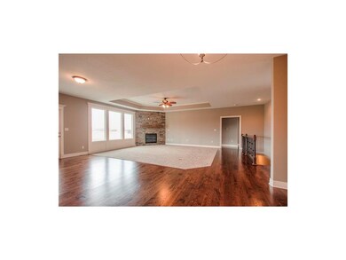 View of the Hearth room.  Ceiling fan and raised c