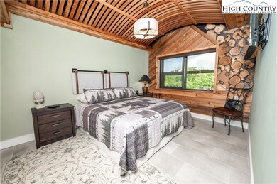 Primary bedroom features custom wood wall and ceil