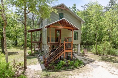 RAISED COTTAGE WITH THREE CUSTOM IRON & WOOD STAIR