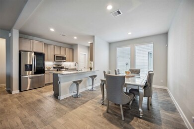 Modern open-concept kitchen with stainless steel a