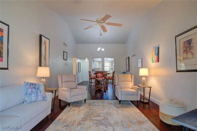 Living area with visible vents, high vaulted ceili