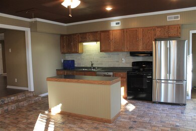 stone tile flooring, plenty or cabinets, island an
