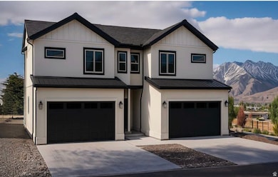 Modern farmhouse featuring a metal roof, an attached garage, a mountain view, and driveway