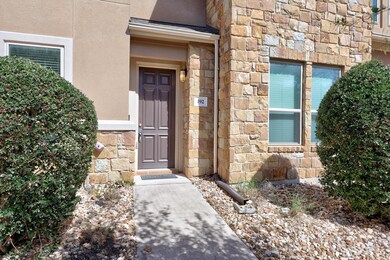 Doorway to property featuring stone siding and st