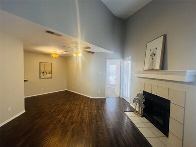 Unfurnished living room with a tile fireplace, a t