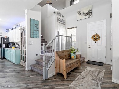 Foyer entrance with wood finished floors, stairs,