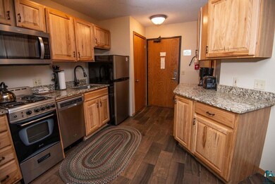 Kitchen with light stone countertops, stainless st