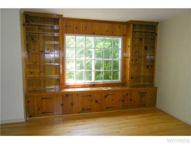 Living Room Framed by a huge rhododendron, this mu