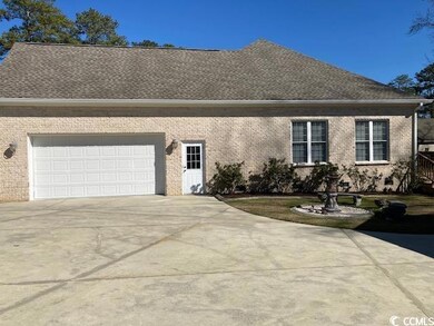 View of front of house with brick siding, driveway