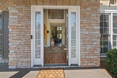 Entrance to property with stone siding