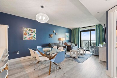 Dining room with a textured ceiling, a wall of win