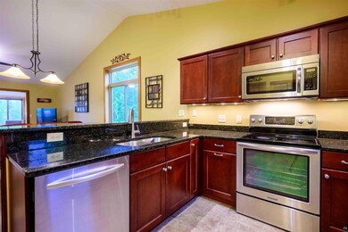 Kitchen featuring kitchen peninsula, dark stone co