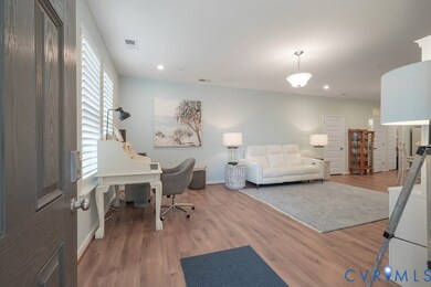Office space with wood finished floors and recessed lighting