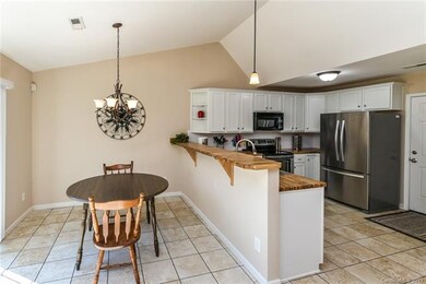 Kitchen with breakfast bar open to dining area