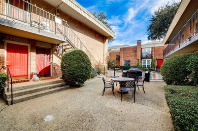 View of front entry door and common patio area