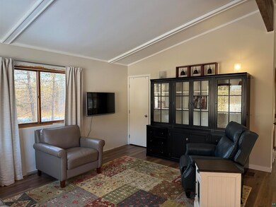 Living room featuring vaulted ceiling with beams, 