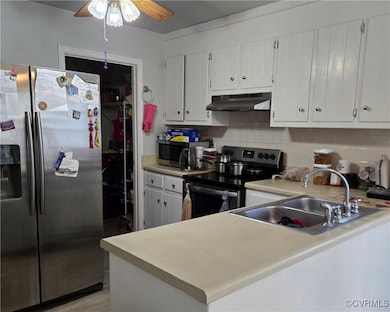 Kitchen with ceiling fan, backsplash, appliances w