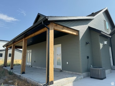 Back of house with a patio
