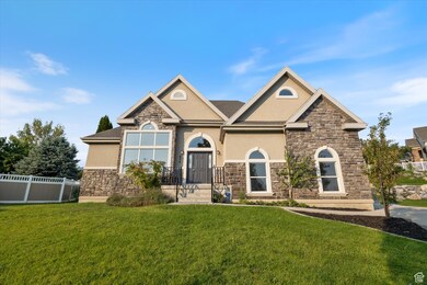 View of front facade featuring stone siding and stucco siding