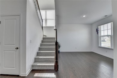 Stairs with visible vents, baseboards, and wood fi