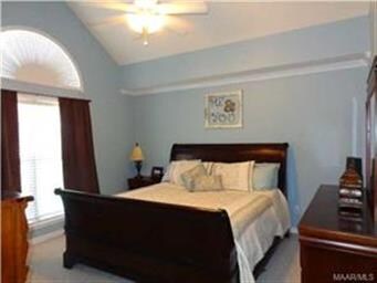 THE MAIN BEDROOM HOLDS A TALL CEILING