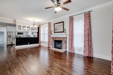 Living room featuring crown molding, hardwood floo