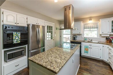 Kitchen island with granite counters, subway tile 
